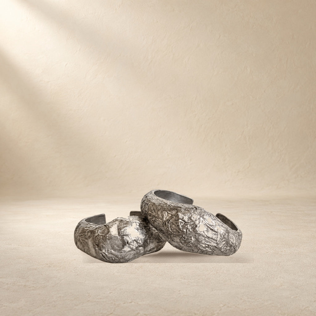 Silver Strata bracelet resting on a warm cream surface