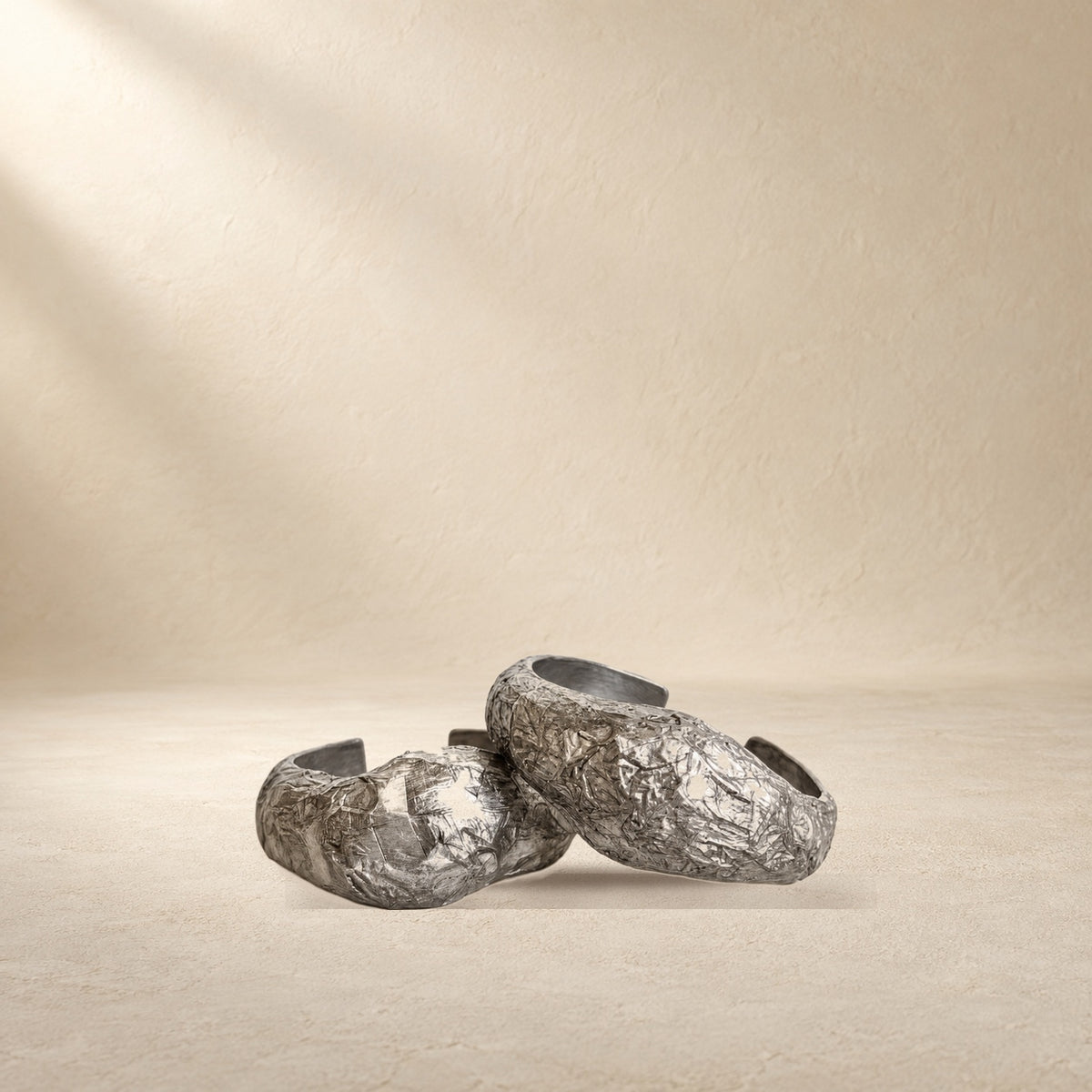 Silver Strata bracelet resting on a warm cream surface