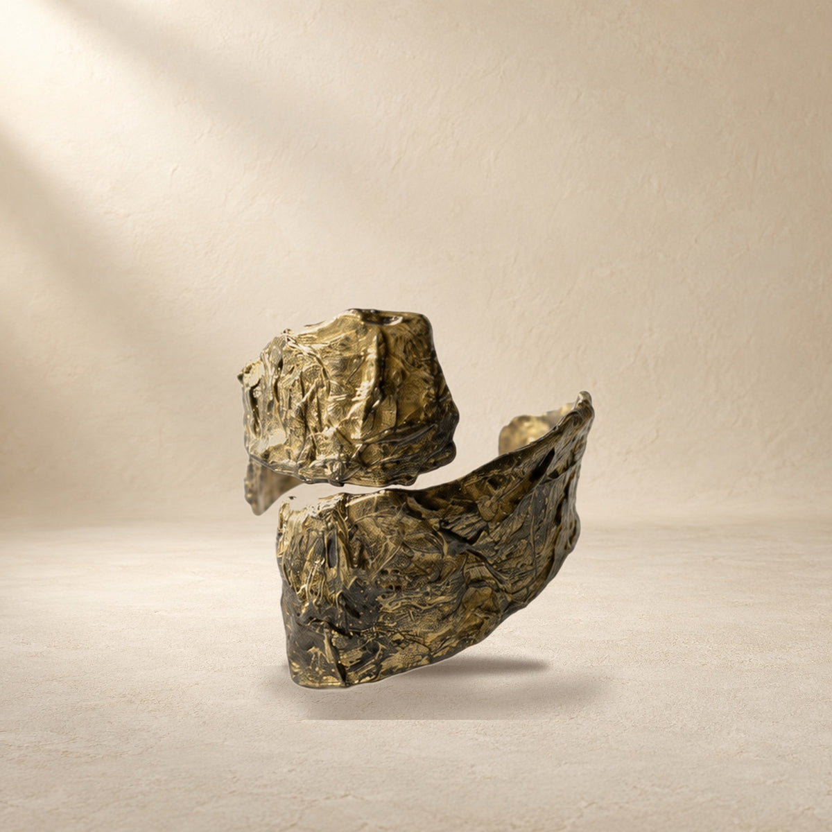 Divided Current bracelet resting on a warm cream surface