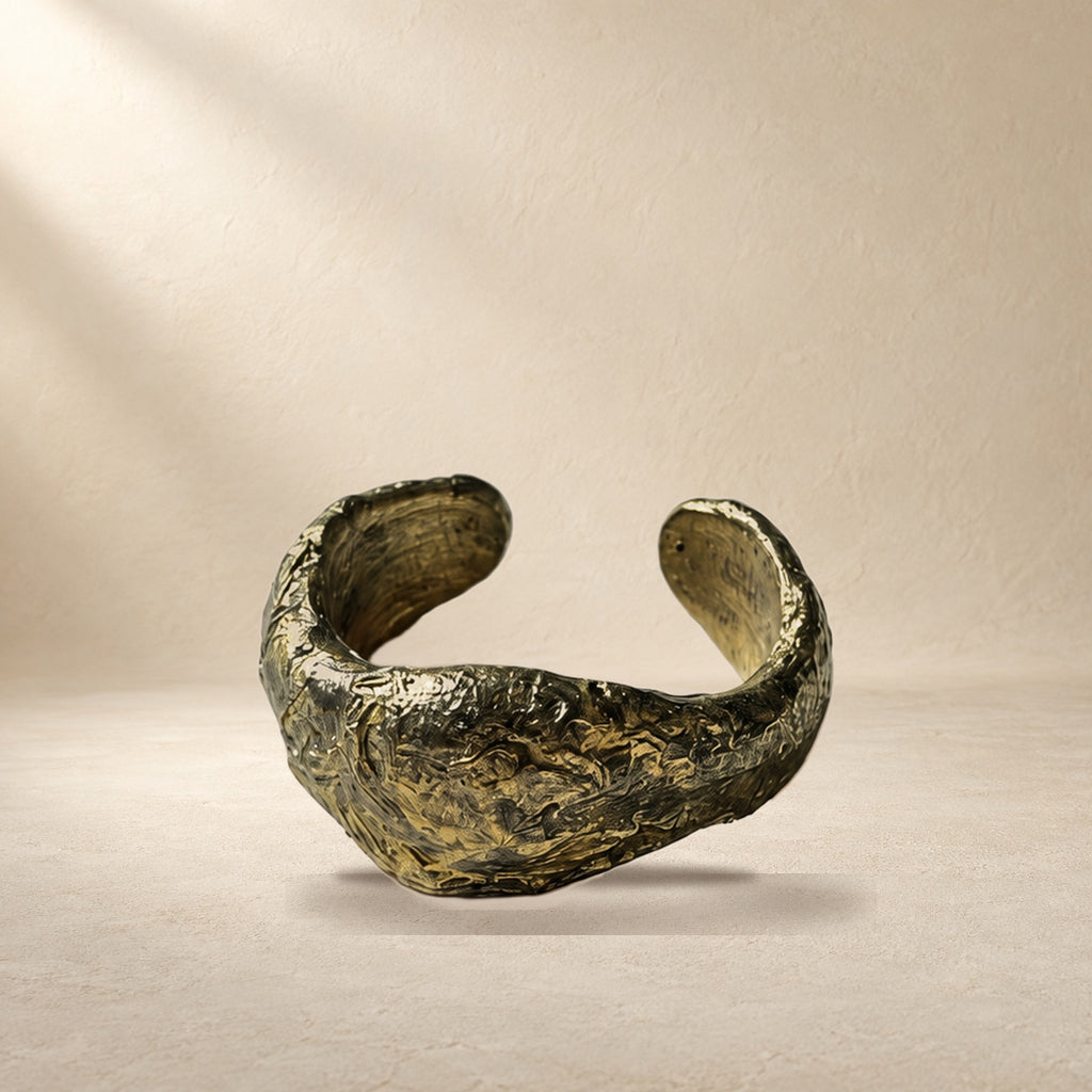 Quiet Compression bracelet resting on a warm cream surface