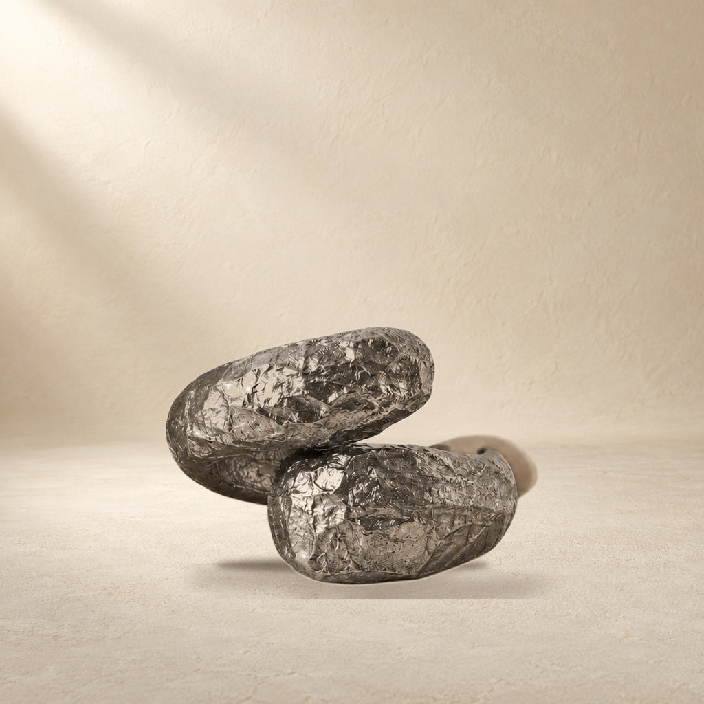 Held Orbit bracelet resting on a warm cream surface