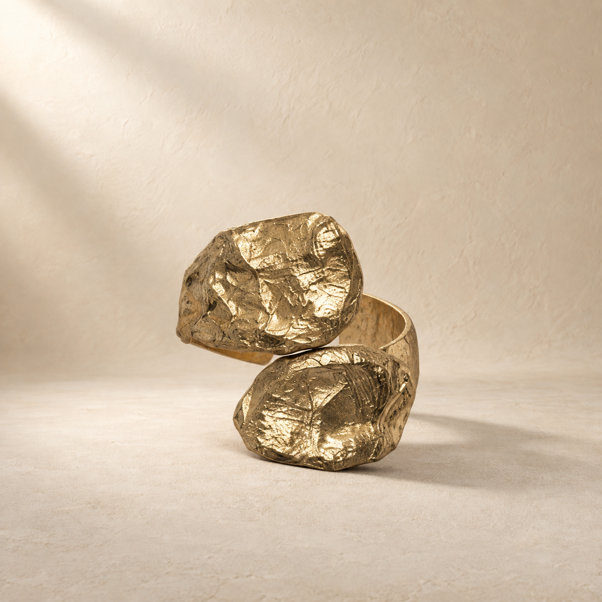 Twin Tension gold-toned sculptural paper cuff bracelet in a warm cream setting — Niksa Design