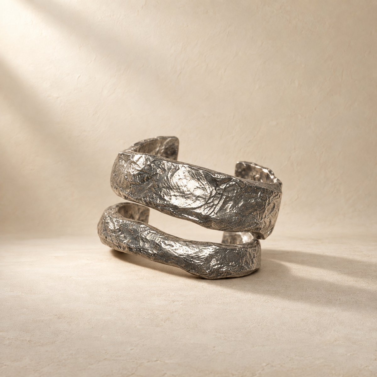 Crosscurrent silver-toned sculptural paper cuff bracelet in a warm cream setting — Niksa Design