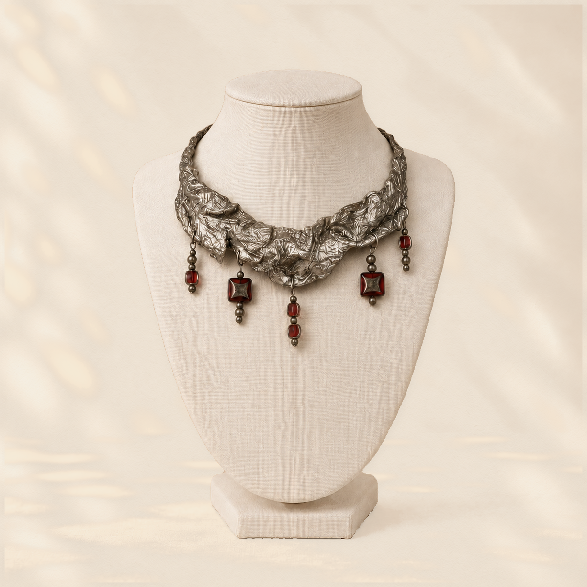Garnet Trace — Sculptural Paper Necklace on warm cream background