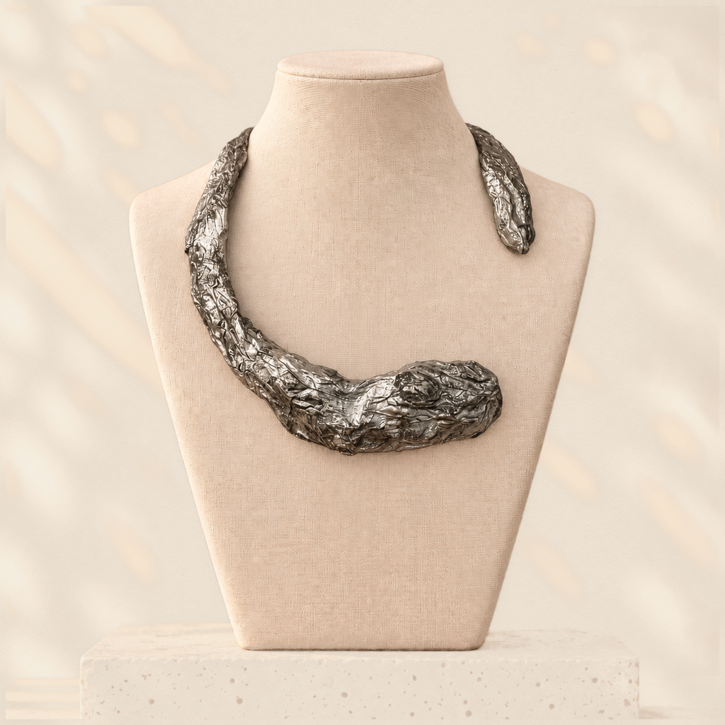 Gilded Compression — Sculptural Paper Collar Necklace on warm cream background