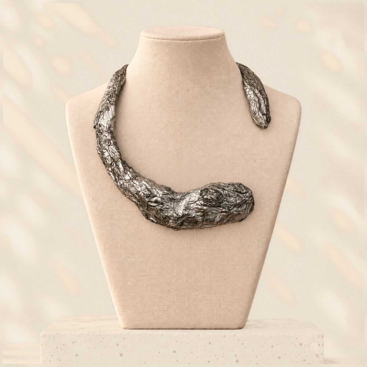 Gilded Compression — Sculptural Paper Collar Necklace on warm cream background