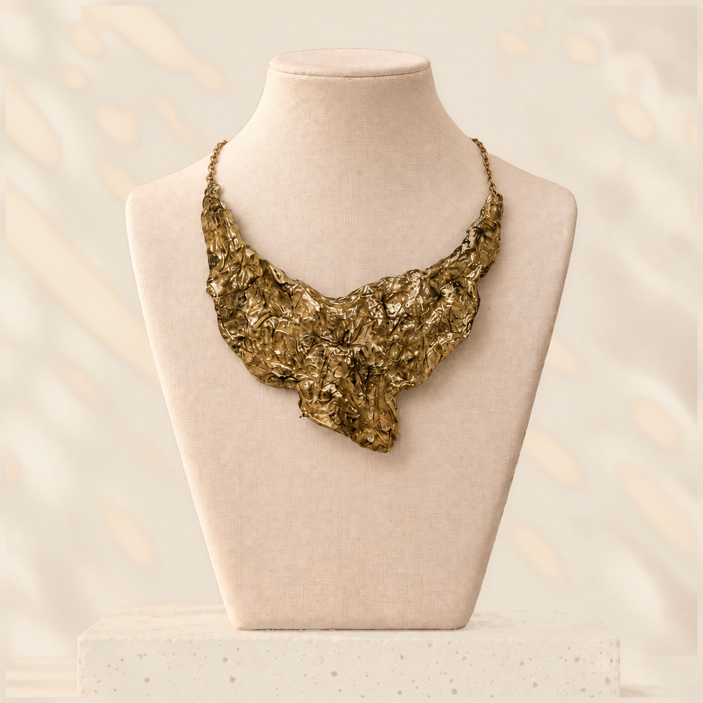 Gilded Fault — Sculptural Paper Bib Necklace on warm cream background