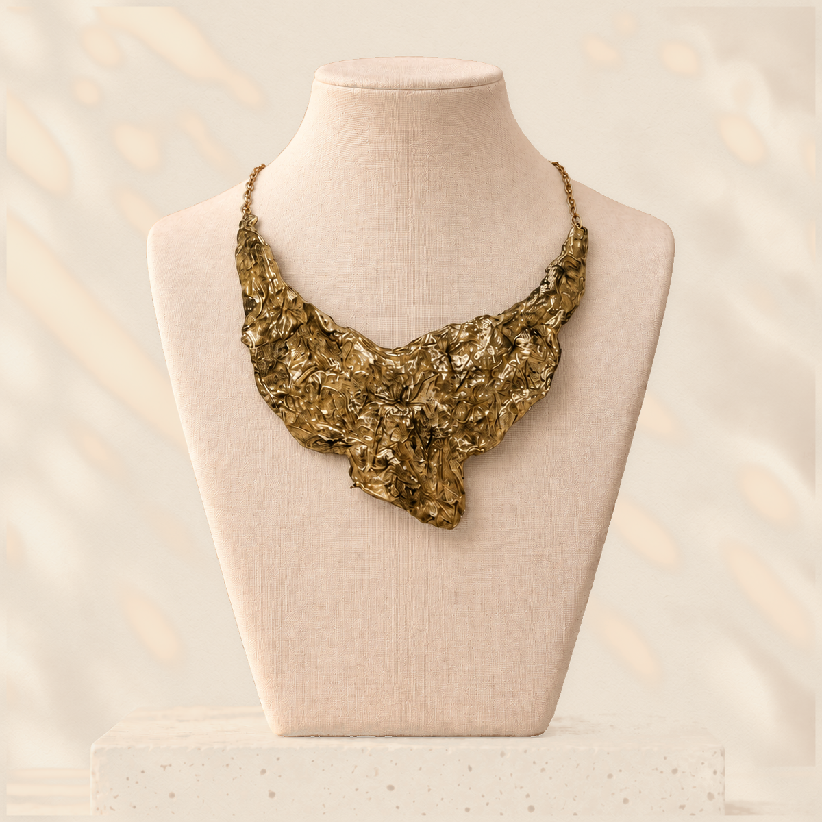 Gilded Fault — Sculptural Paper Bib Necklace on warm cream background