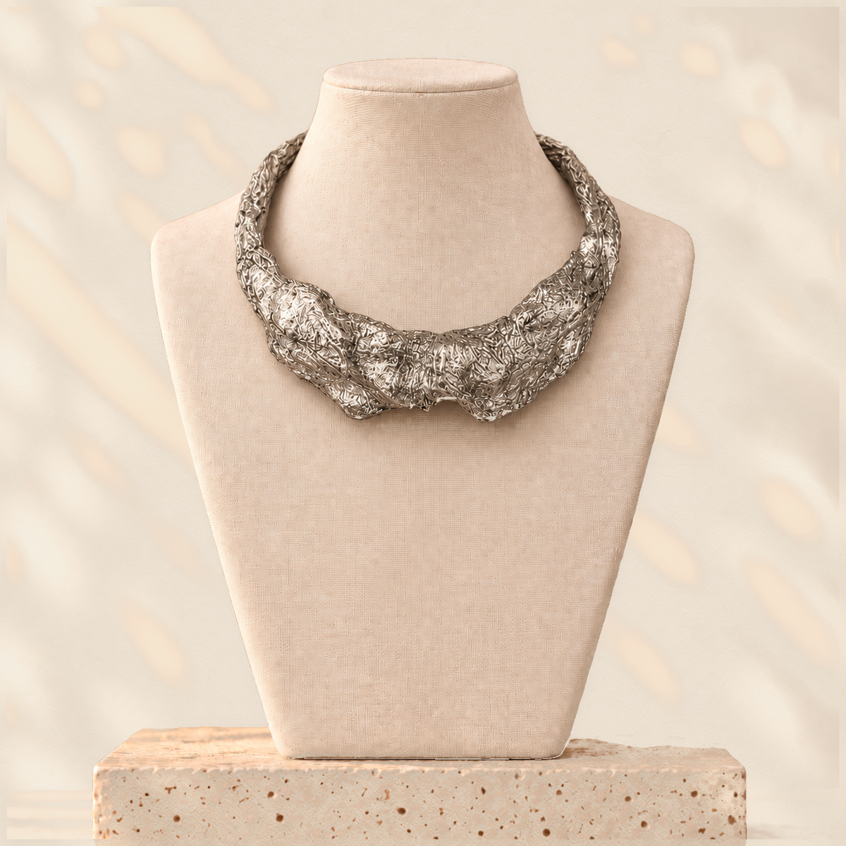 Silver Compression — Sculptural Paper Collar Necklace on warm cream background