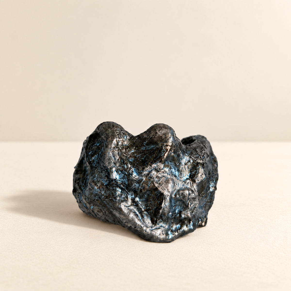 Storm Fold — Sculptural Paper Cuff Bracelet resting on a warm ivory studio surface with a natural grounding shadow — Niksa Design