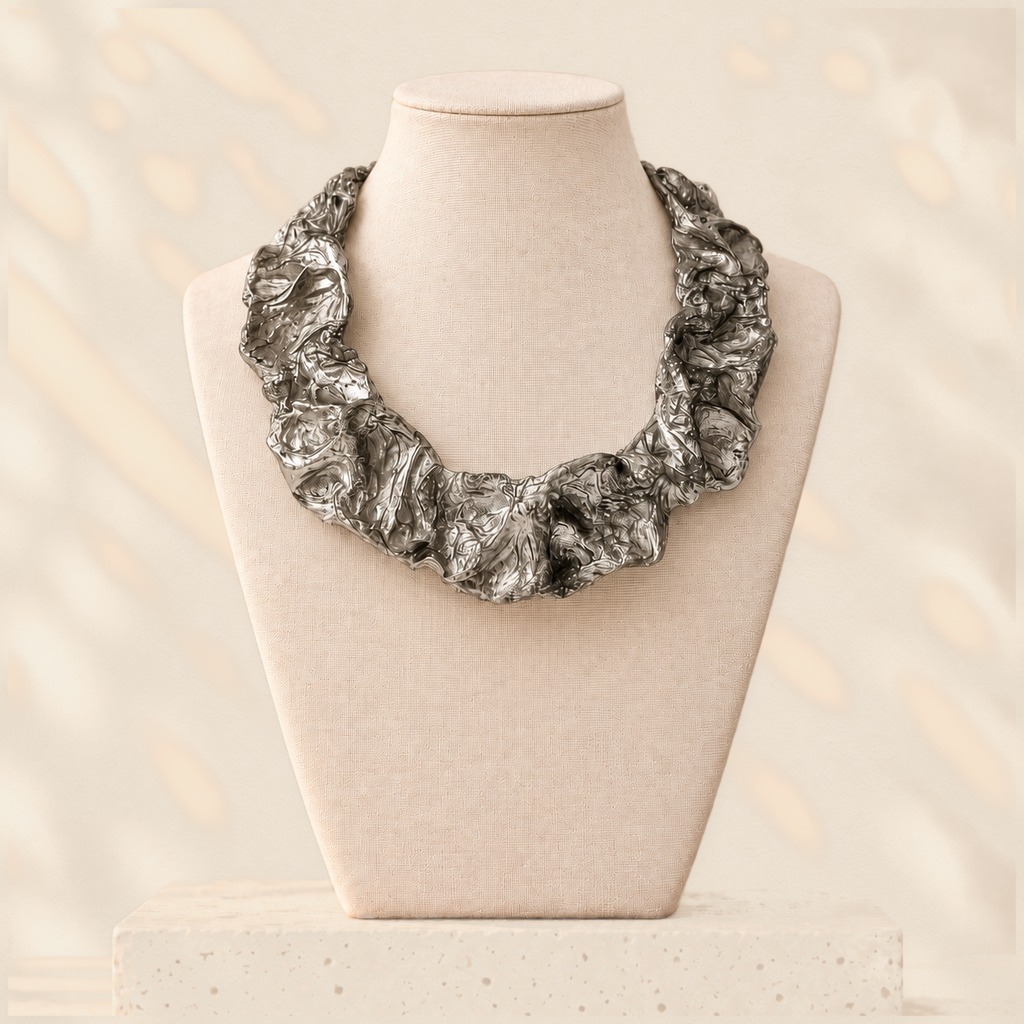 Silver Current — Sculptural Paper Collar Necklace on warm cream background