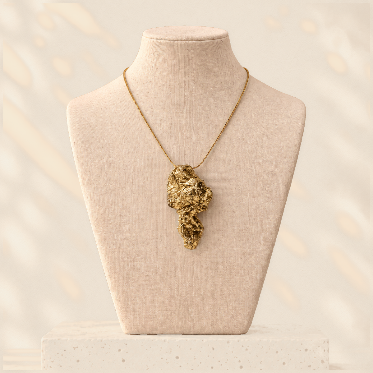 Compressed Drop — Sculptural Paper Pendant Necklace on warm cream background