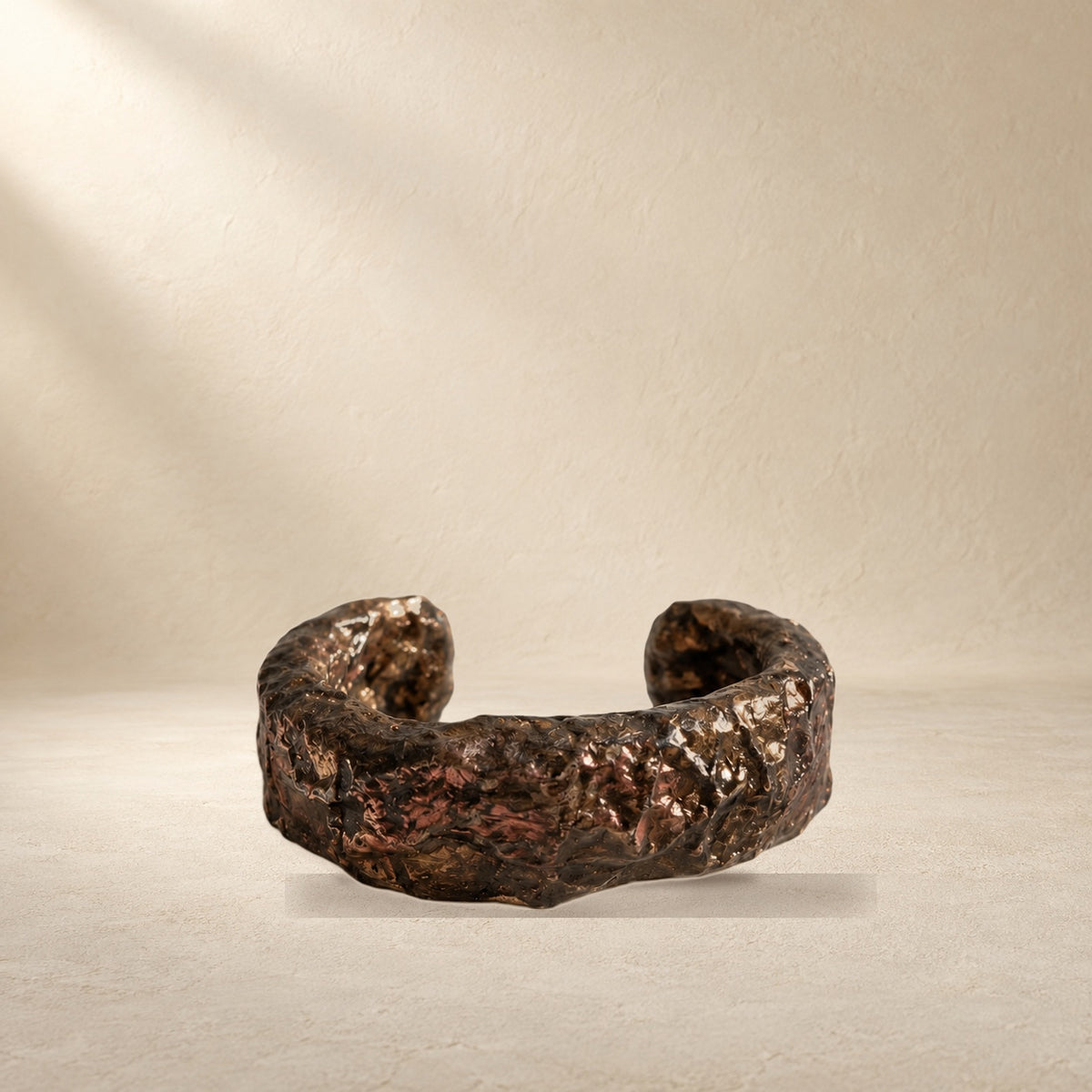 Bronze Horizon bracelet resting on a warm cream surface