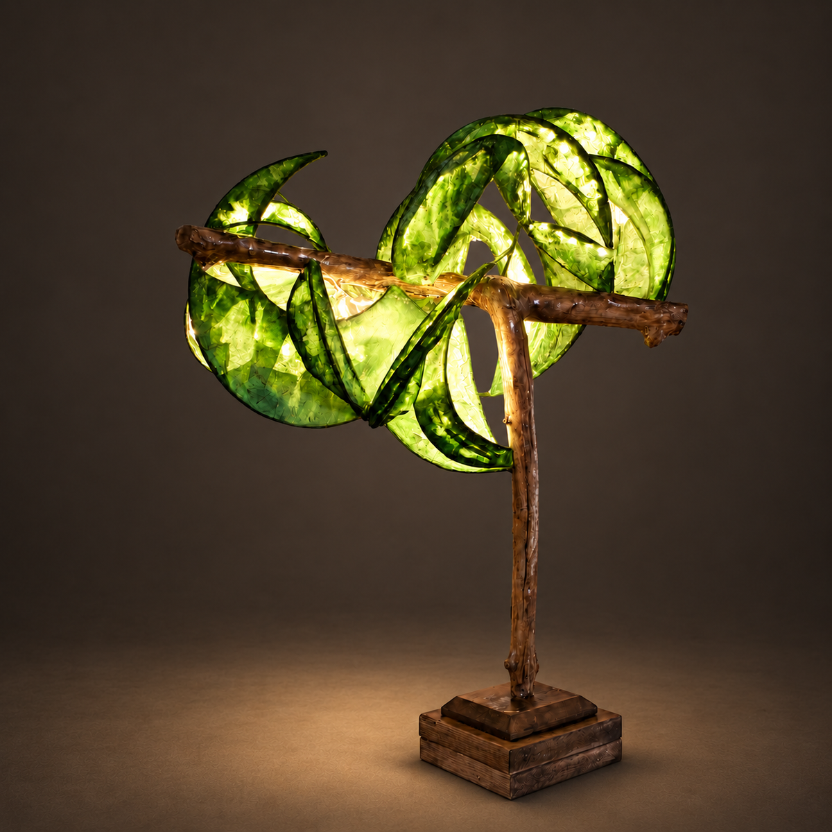 Dreaming Willow sculptural lamp illuminated against warm charcoal