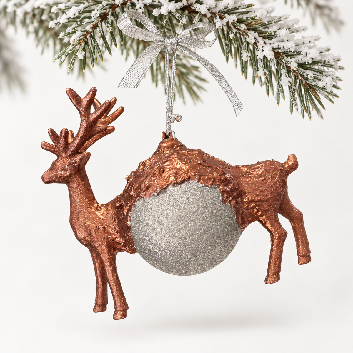 Copper-toned deer form with a textured silver-toned sphere and a silver ribbon.