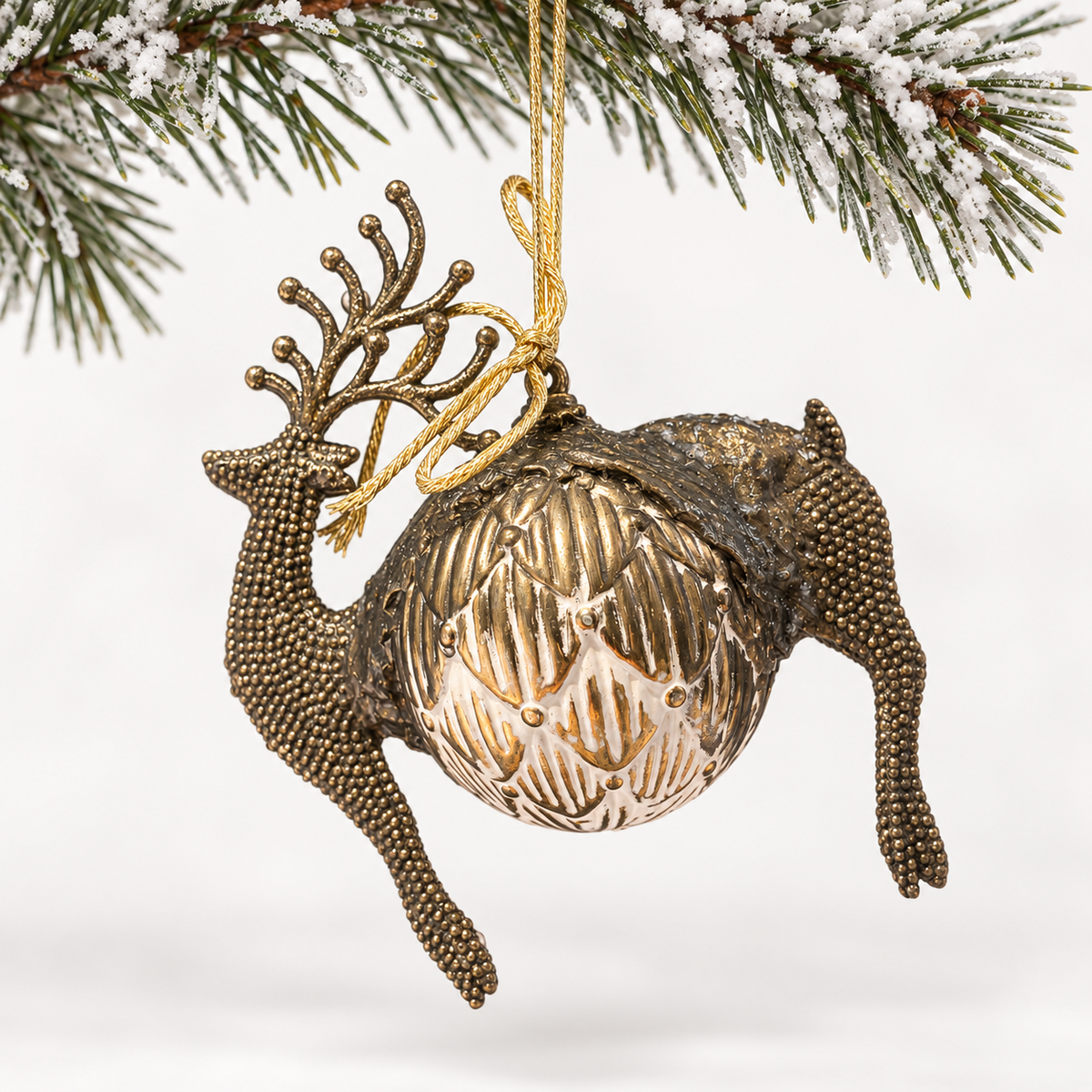 Bronze-toned deer form with beaded antlers and a patterned ivory and gold-toned sphere.