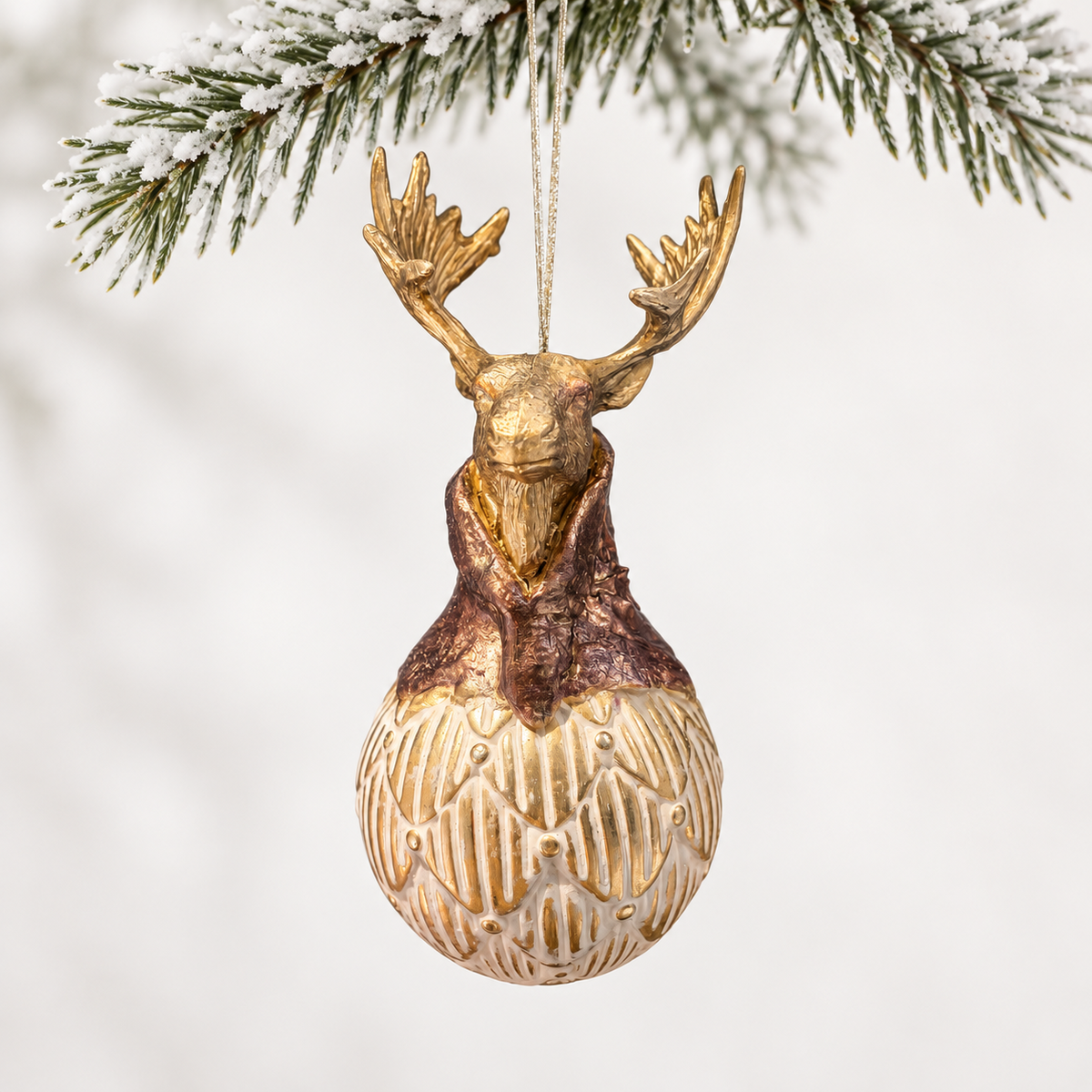 Gold-toned stag head with a bronze-toned collar above a patterned ivory and gold-toned sphere.