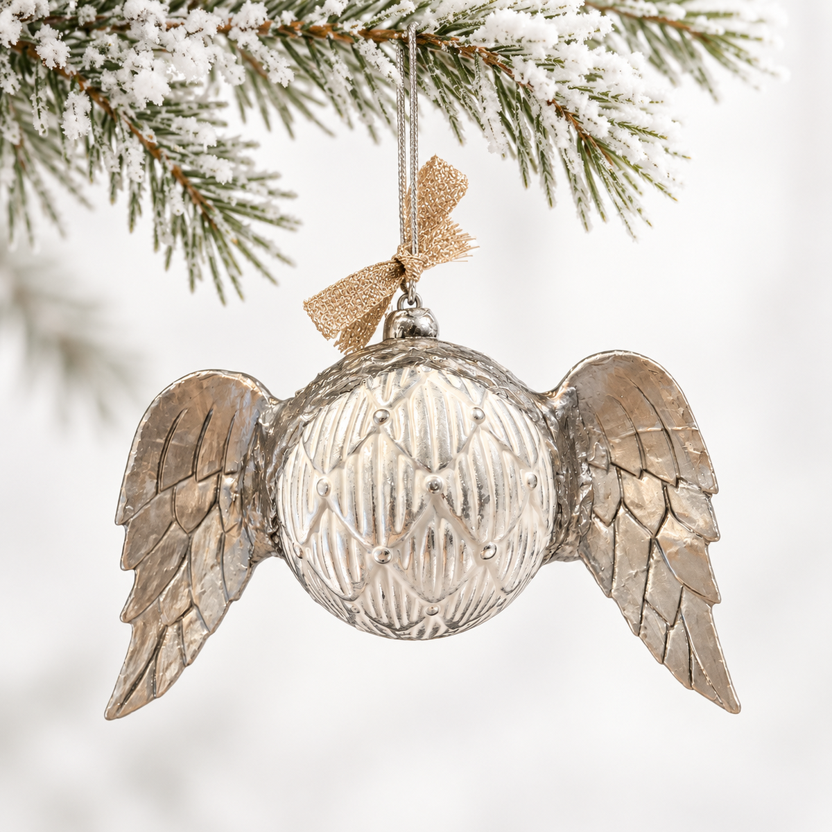 A patterned ivory and silver-toned sphere framed by sculpted silver-toned wings.