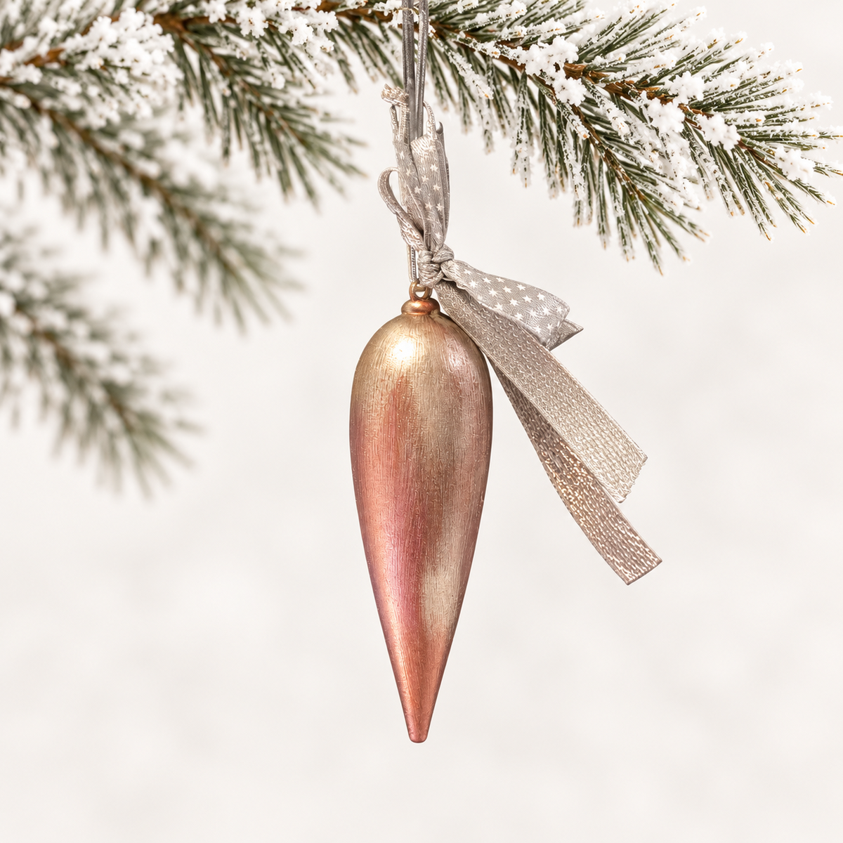 Long tapered finial in rose and gold tones with a silver star-patterned ribbon.