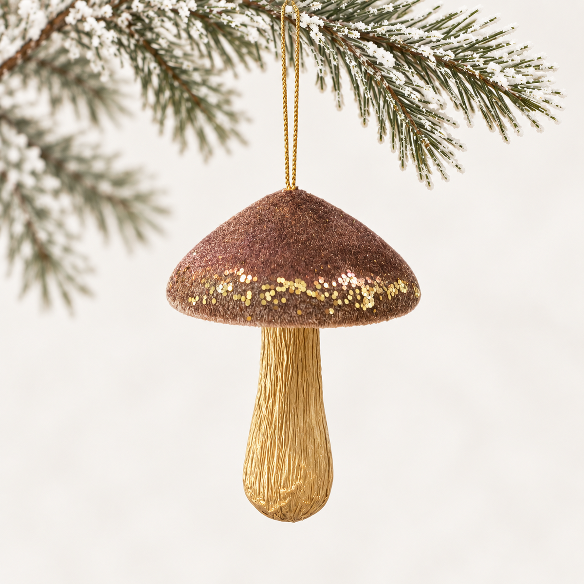 Mushroom form with a bronze-toned cap, gold-coloured sparkle accents and a gold-toned stem.