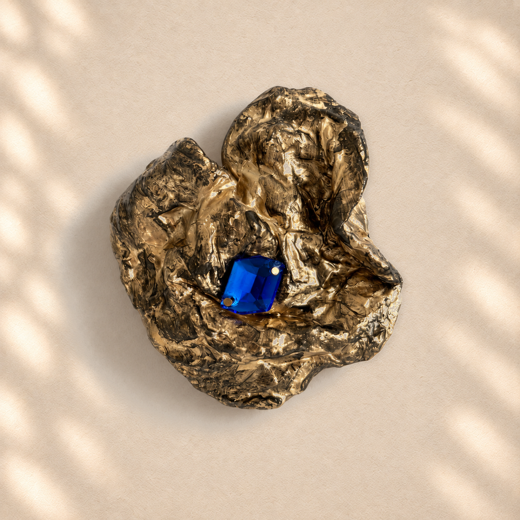 Cobalt Cradle brooch on warm cream background