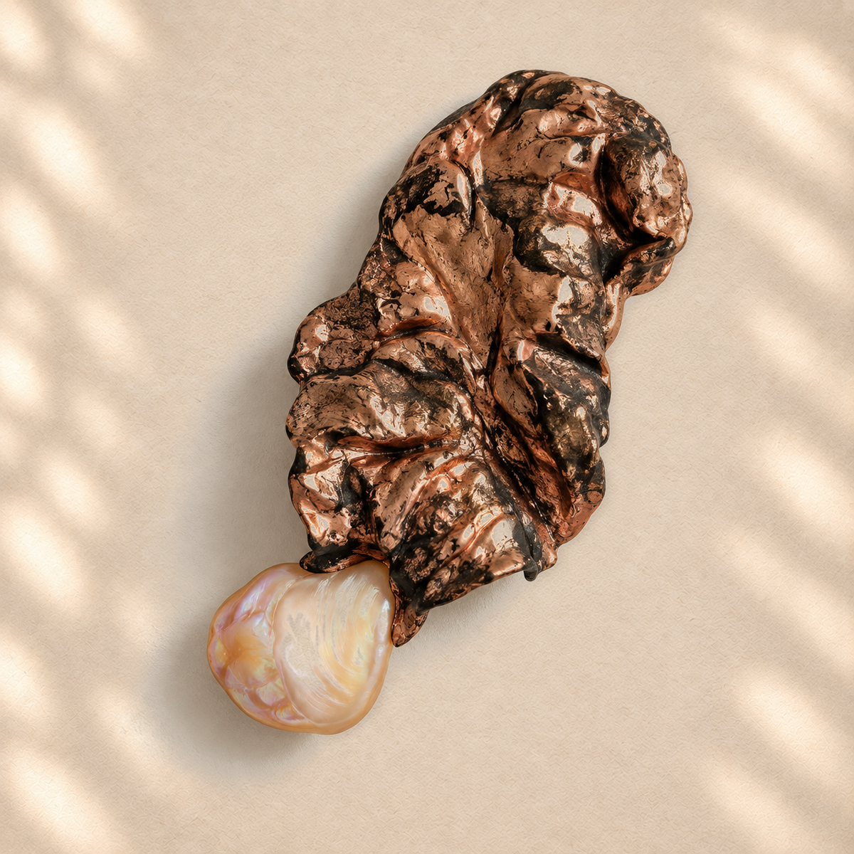 Pearl Current brooch on warm cream background