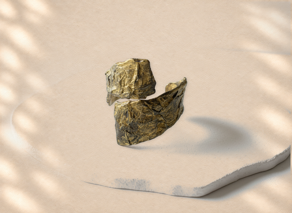 Divided Current — Sculptural Paper Cuff Bracelet on warm cream background
