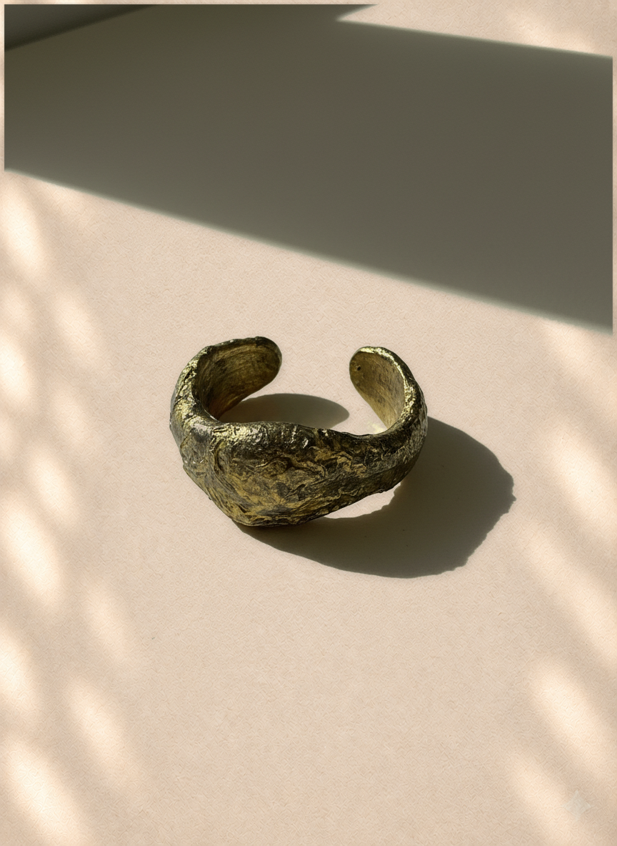 Quiet Compression — Sculptural Paper Cuff Bracelet on warm cream background