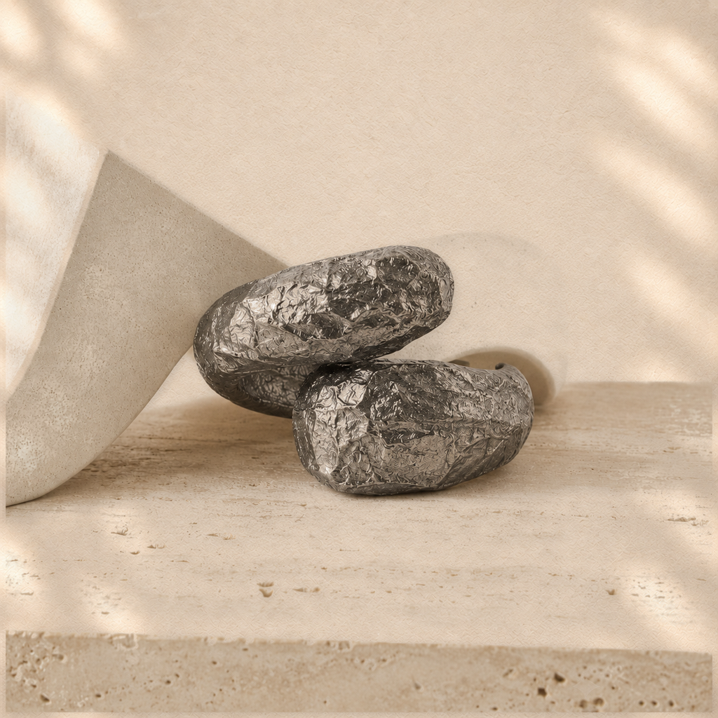 Held Orbit — Sculptural Paper Cuff Bracelet on warm cream background