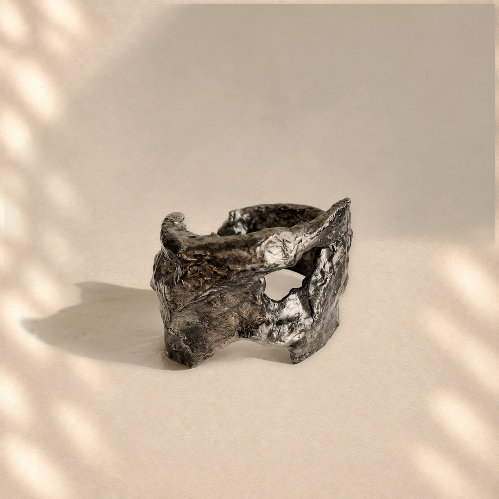 Rifted Span — Sculptural Paper Cuff Bracelet on warm cream background