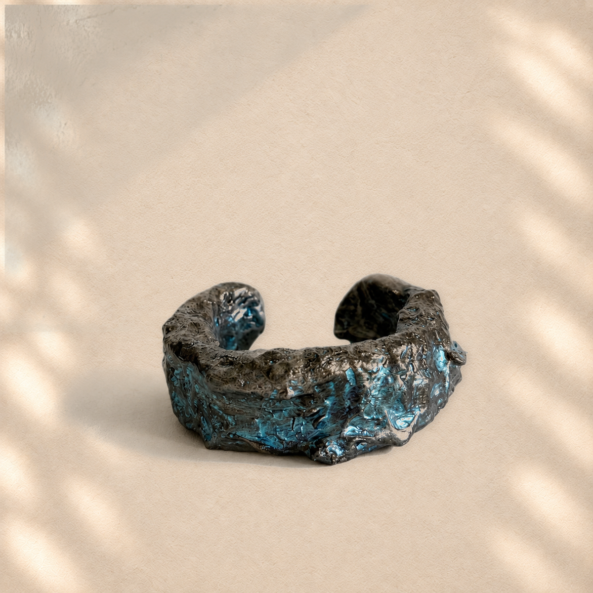 Tidal Fault — Sculptural Paper Cuff Bracelet on warm cream background