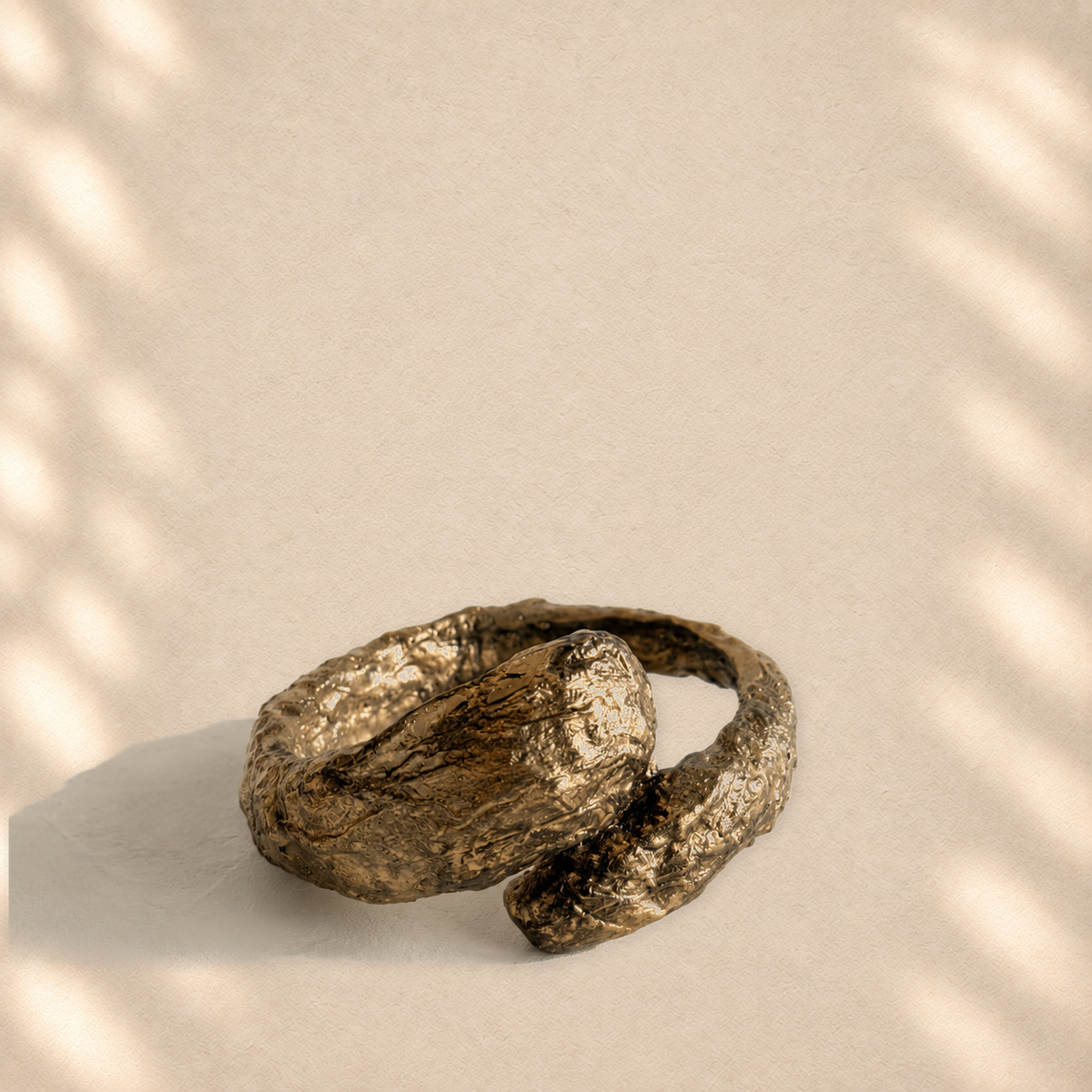 Gilded Confluence — Sculptural Handmade Paper Cuff Bracelet on warm cream background