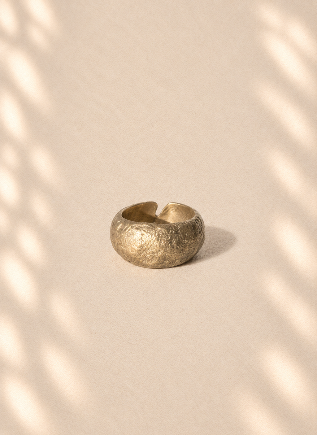 Bronze Aperture — Sculptural Paper Ring product only on warm cream background