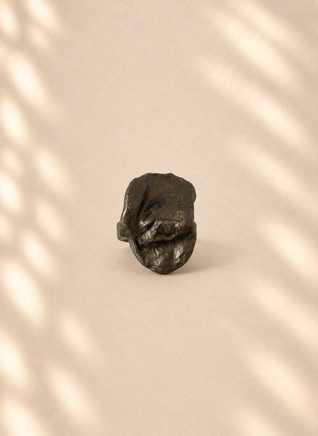 Graphite Crest — Sculptural Paper Ring product only on warm cream background
