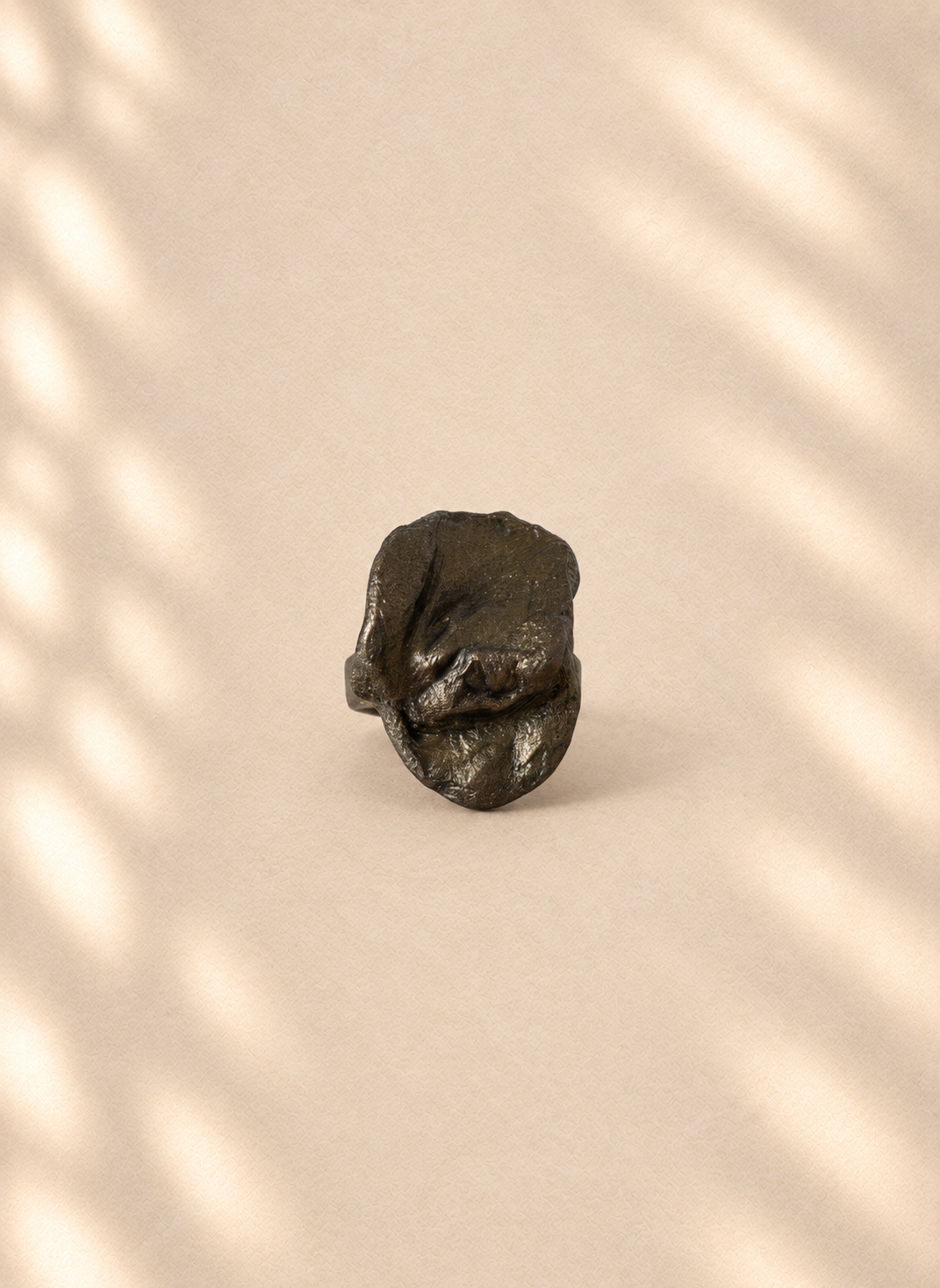 Graphite Crest — Sculptural Paper Ring product only on warm cream background