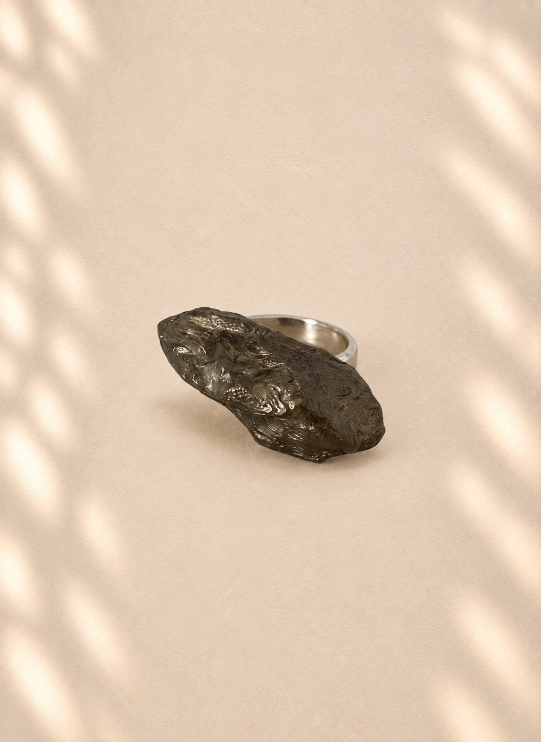 Graphite Fold — Sculptural Paper Ring product only on warm cream background