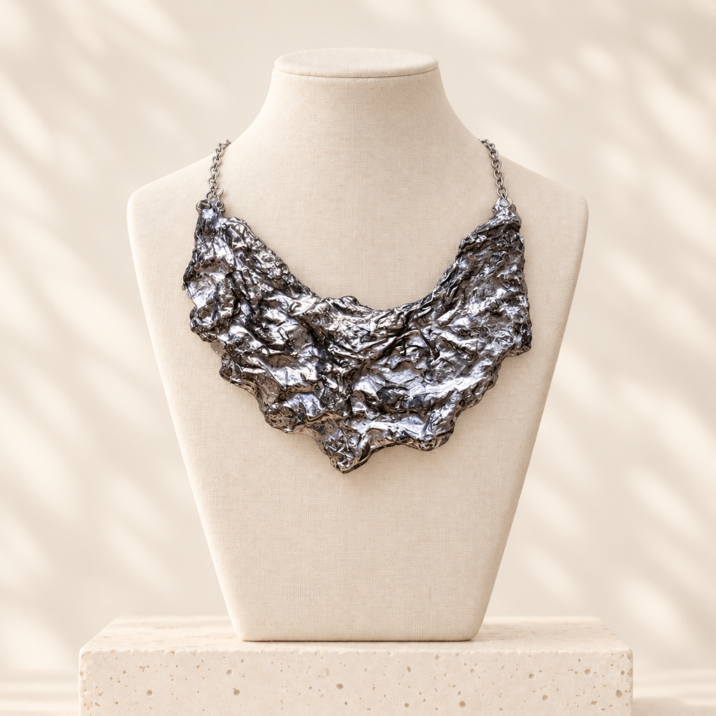 Silver Fault sculptural handmade-paper bib necklace on an ivory linen bust