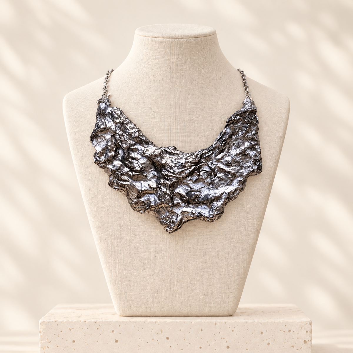 Silver Fault sculptural handmade-paper bib necklace on an ivory linen bust