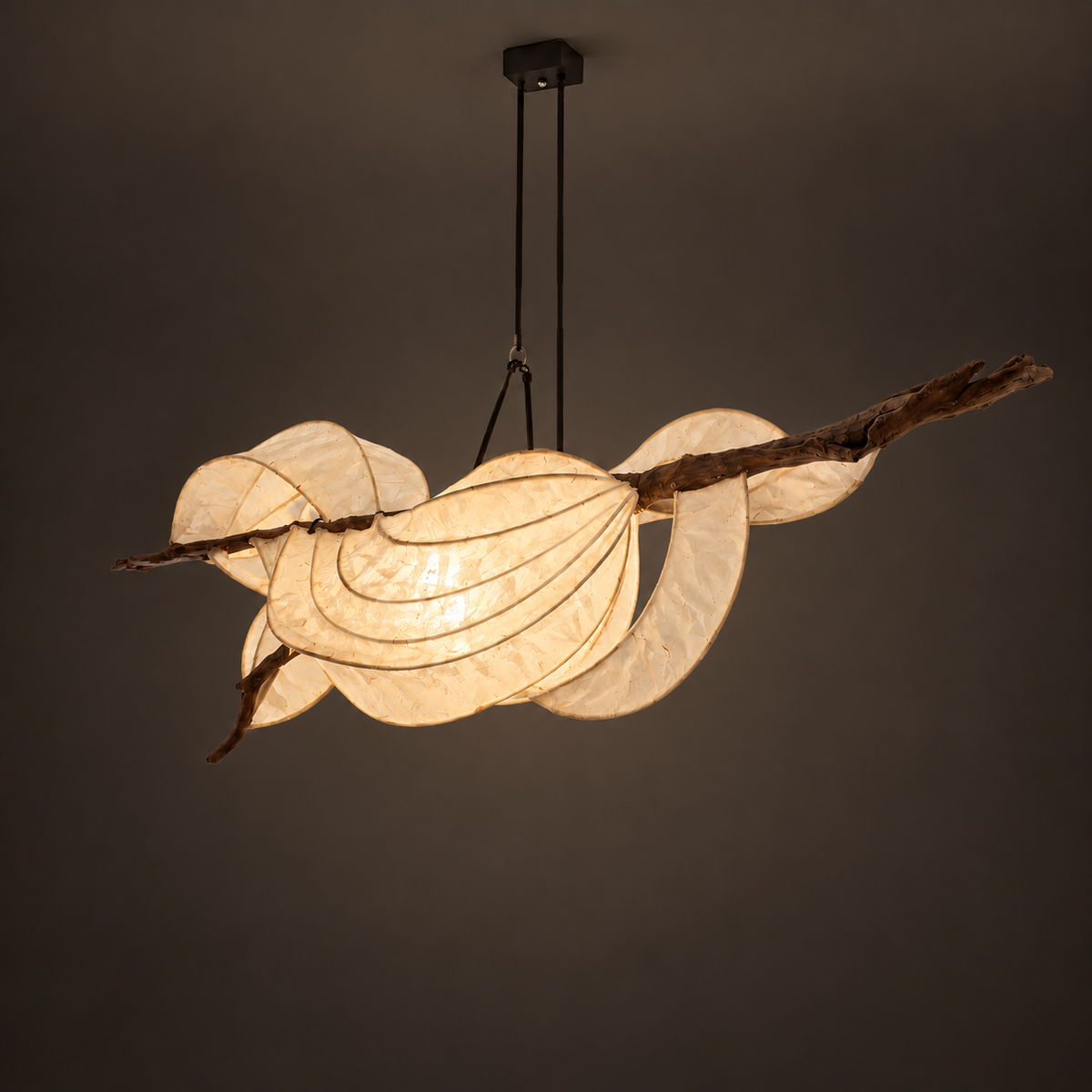 Sky Bloom sculptural lamp illuminated against warm charcoal