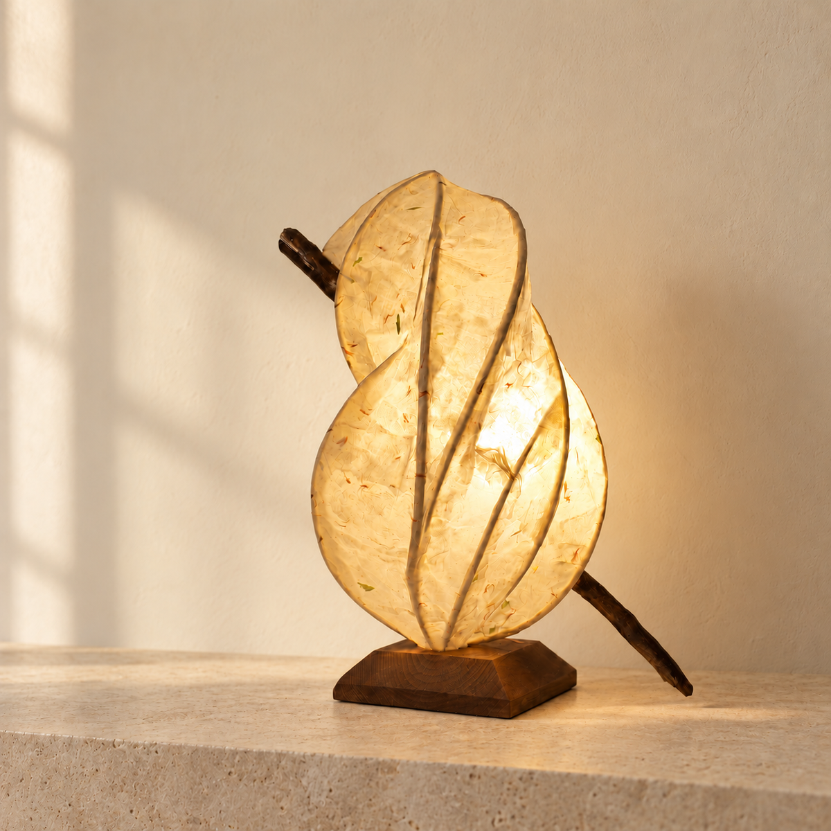 Zarreh sculptural lamp, opposite side view on a pale stone console